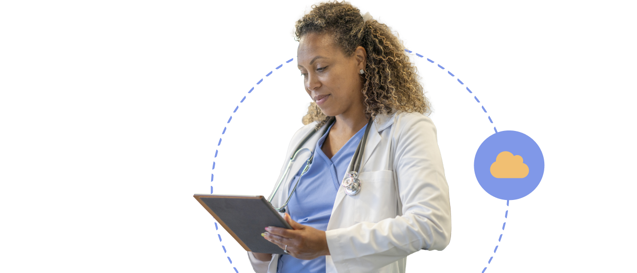 Doctor or nurse in a white coat working on a tablet device